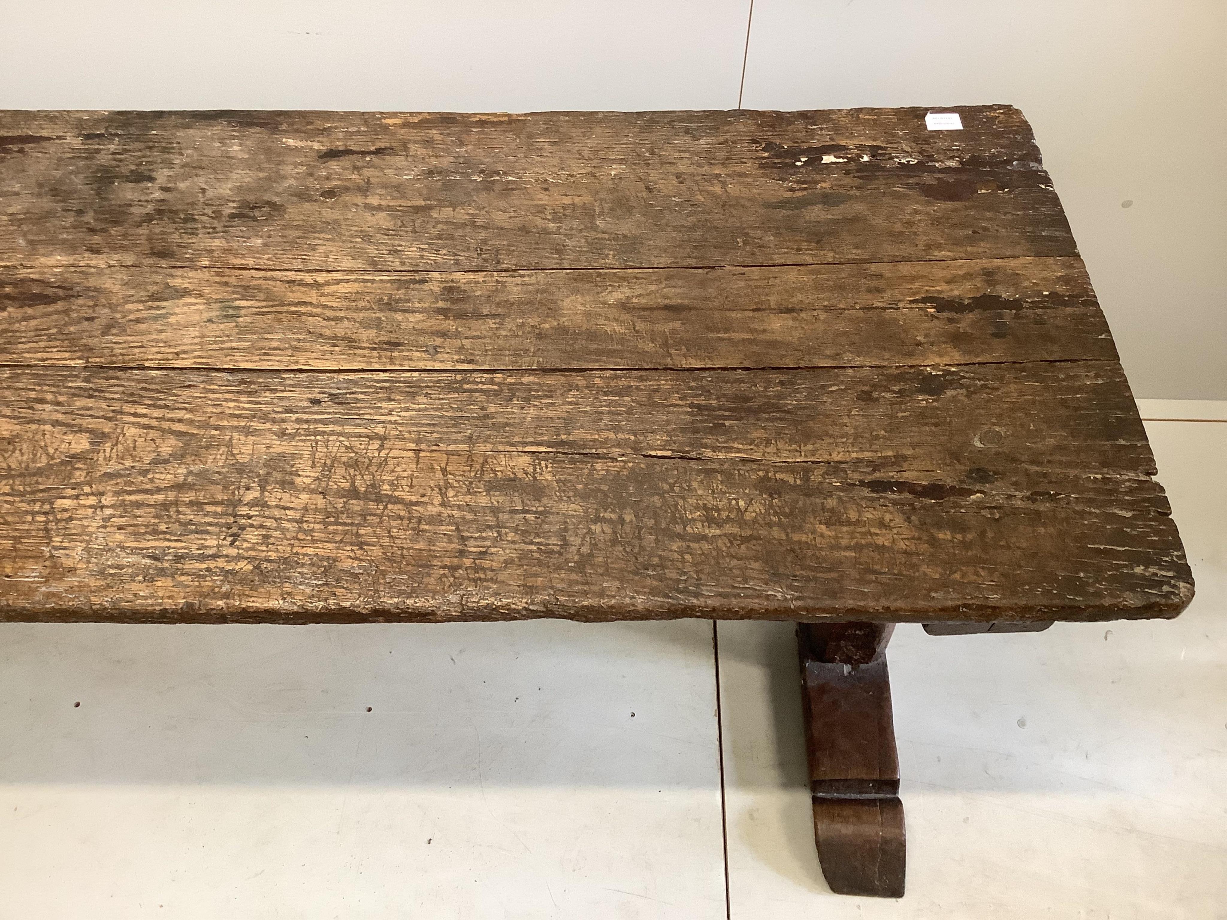 A 17th century elm topped oak refectory table, width 199cm, depth 69cm, height 75cm. Condition - poor-fair